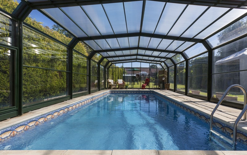 Inground swimming pool with pool enclosure