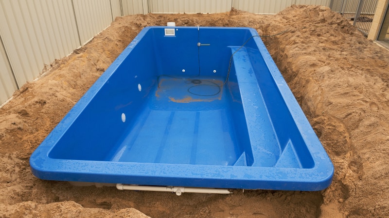 Fiberglass pool shell being buried