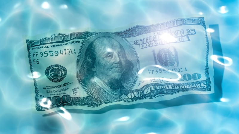 100 dollar bill underwater in a swimming pool