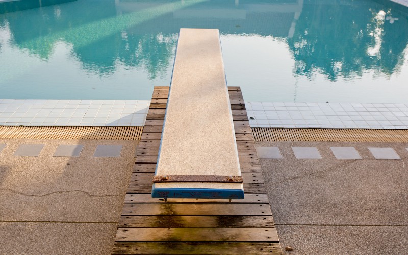 Overhead view of a diving board at an inground swimming pool