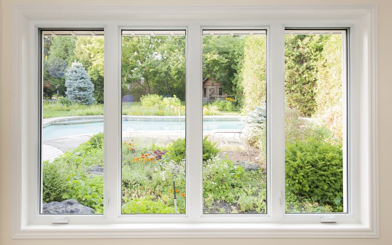 Vue d'une piscine extérieure depuis l'intérieur d'une maison