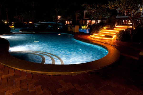 Swimming pool lit from inside and outside