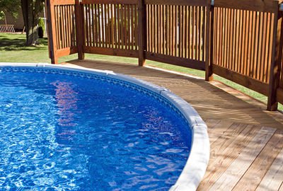 Above ground pool with deck and fence