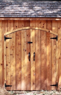 Closeup of a cedar pool shed with doors closed