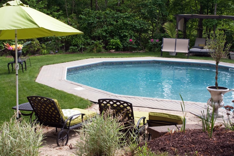 View of an inground swimming pool from the vantage point of inside a house