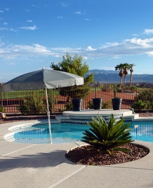 An in-pool umbrella on the baja shelf of an inground swimming pool