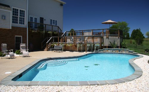 Backyard suburban swimming pool with spacious deck