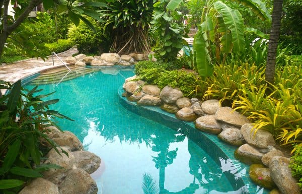 Residential lazy river surrounded by tropical landscaping