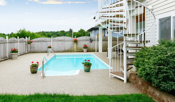 Backyard with a swimming pool enclosed by a fence