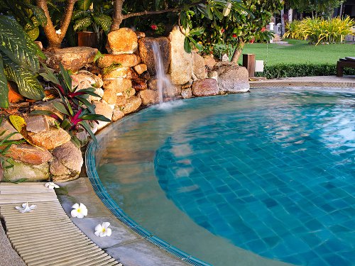 Small round pool with tropical landscaping