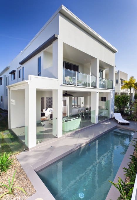 Modern home with swimming pool right outside its backdoor