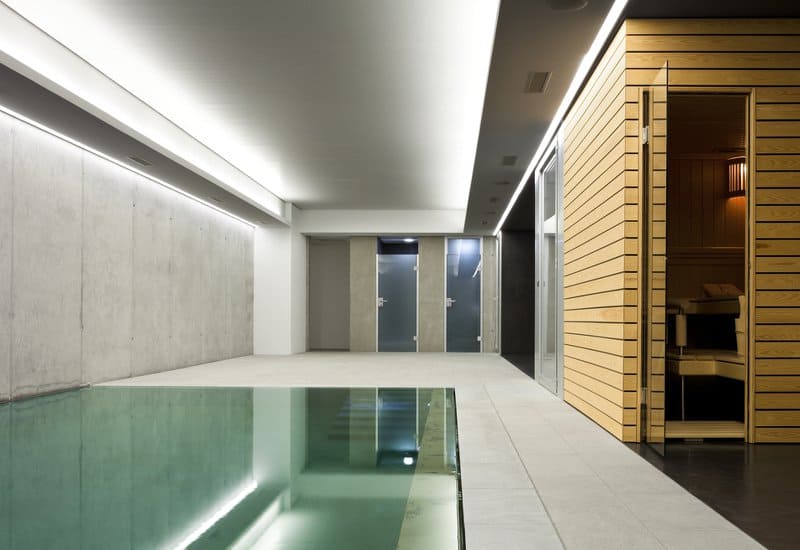 Modern indoor pool with sauna room