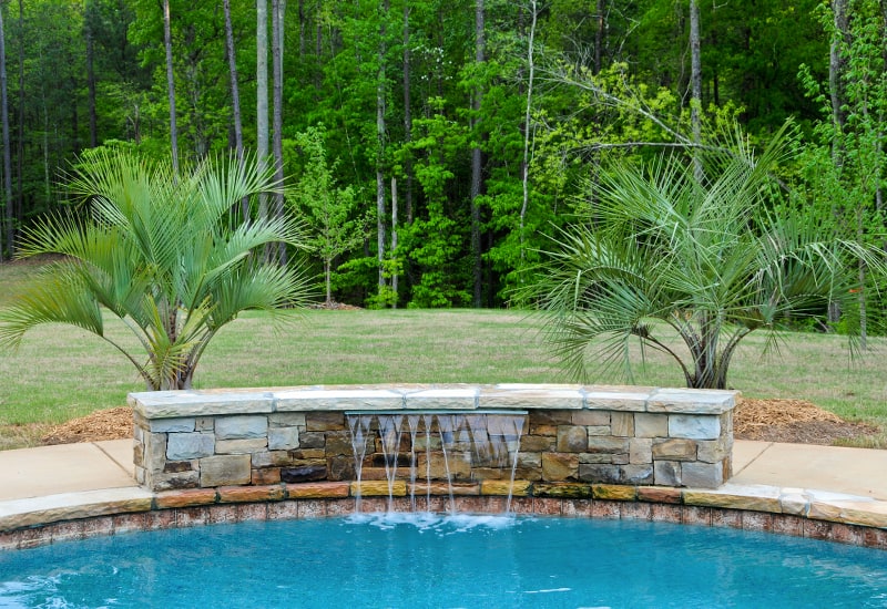 Sleek and modern inground pool waterfall