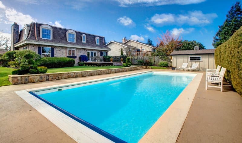 Inground swimming pool in the backyard of a luxury home